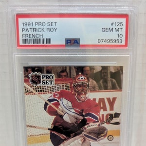 May include: A 1991 Pro Set hockey card featuring Patrick Roy, a goalie for the Montreal Canadiens. The card is graded GEM MT 10 by PSA and has a number of 125.