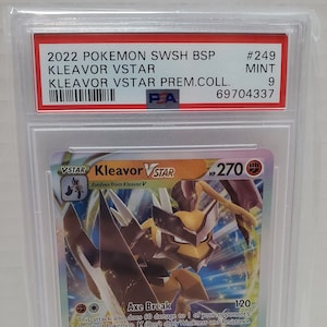 May include: A Pokemon trading card featuring Kleavor VSTAR, a brown and yellow Pokemon with large, sharp claws. The card is from the Sword & Shield Brilliant Stars set and has a holographic finish. The card's HP is 270 and it has two attacks: Axe Break and Rampaging Star.