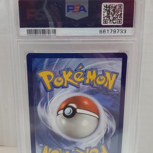 May include: A PSA graded Pokemon card in a clear plastic case with a blue and white border. The card features the Pokemon logo and a Pokeball graphic. The case has a barcode and the number 66179733.