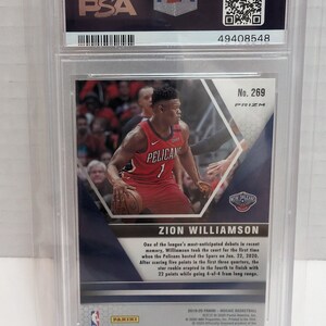 May include: A Zion Williamson basketball trading card from the 2019-20 Panini Mosaic Basketball series. The card is numbered 269 and features a photo of Williamson in his New Orleans Pelicans uniform. The card is graded by PSA.