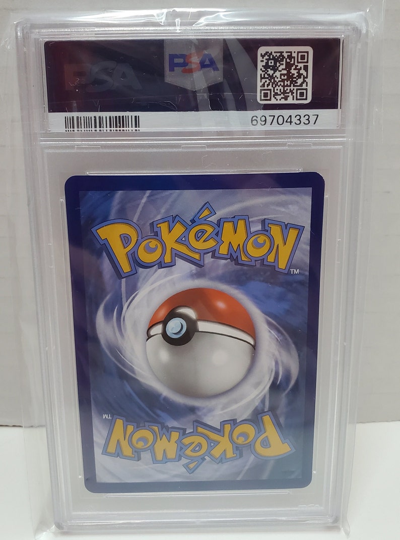 May include: A Pokemon trading card graded by PSA with a blue background and a Pokeball graphic. The card has a PSA 69704337 grading label.