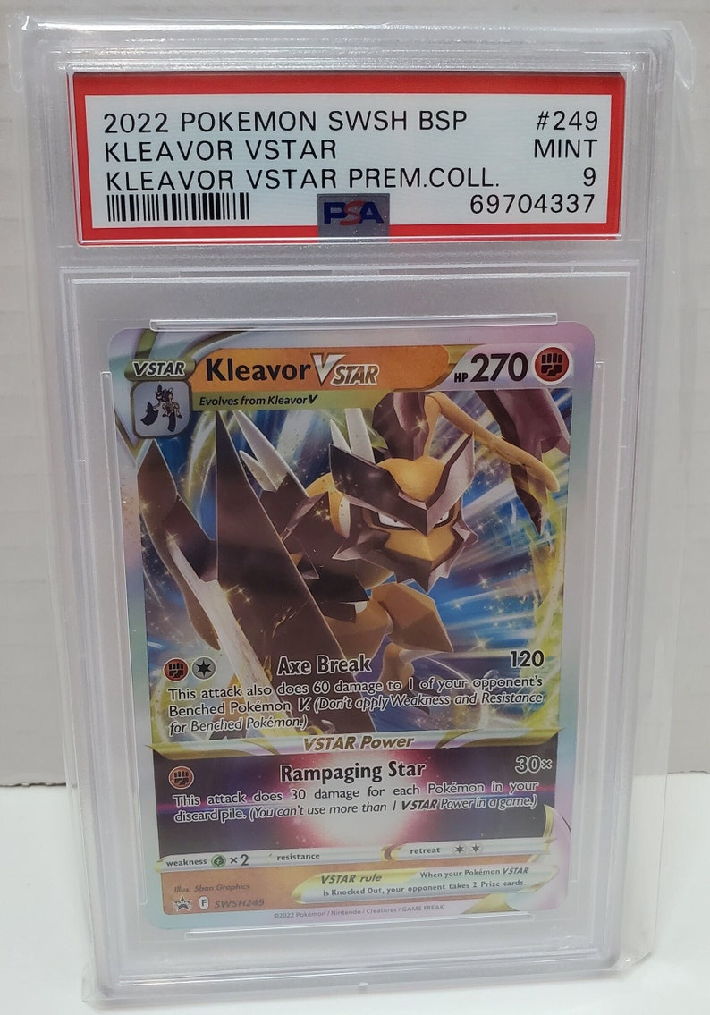 May include: A Pokemon trading card featuring Kleavor VSTAR, a brown and yellow Pokemon with large, sharp claws. The card is from the Sword & Shield Brilliant Stars set and has a holographic finish. The card's HP is 270 and it has two attacks: Axe Break and Rampaging Star.