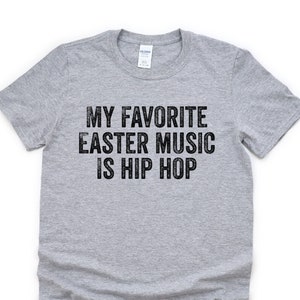 May include: A gray t-shirt with the text "My favorite Easter music is hip hop" printed in black.