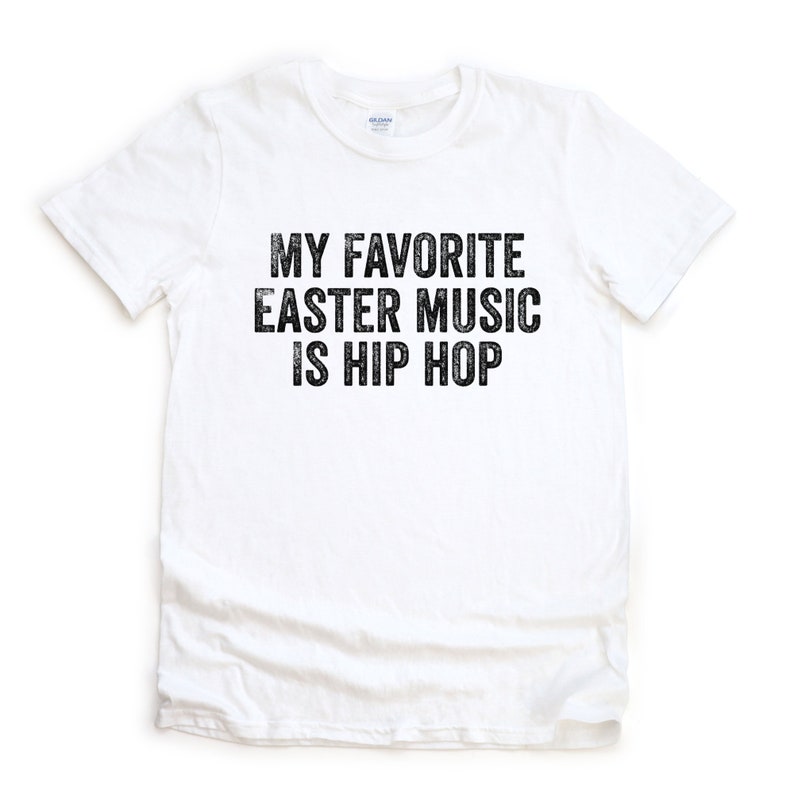 May include: White t-shirt with black text that reads "My favorite Easter music is hip hop."