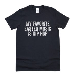May include: Black t-shirt with white text that reads "My favorite Easter music is hip hop".