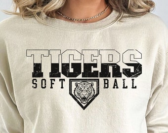 May include: A cream colored sweatshirt with a black graphic that says "TIGERS SOFTBALL" with a tiger head inside a baseball diamond.