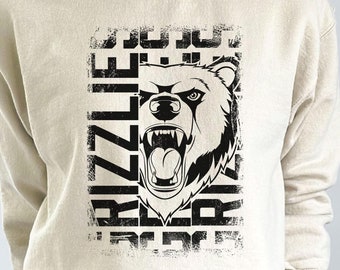 Puede incluir: Una sudadera beige con un estampado gráfico en blanco y negro de la cara de un oso con la palabra "Grizzlie" repetida en una fuente desgastada.