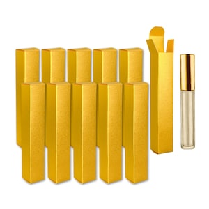 May include: A set of 12 gold cardboard boxes with a roll-top closure. The boxes are ideal for packaging small items, such as jewelry, perfume, or candles. A clear glass bottle with a gold cap is also included.
