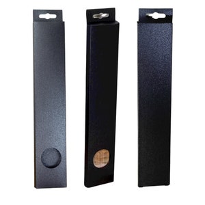 May include: Three black cardboard boxes with hanging holes at the top. The boxes have a textured surface and a round cutout on the front. The middle box has a wooden insert visible through the cutout.