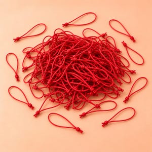May include: A large collection of small, bright red elastic cord loops. Each individual loop is formed by a thin, flexible red string tied into a secure knot at the base, creating a teardrop shape. The loops are scattered in a dense pile.