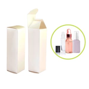 May include: Two white cardboard boxes with a flap top, one open and one closed. The boxes are designed to hold small bottles. A close-up of three glass bottles with different droppers and caps is shown in a circle.