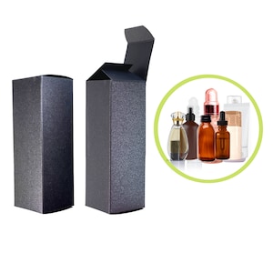 May include: Two black cardboard boxes with a textured surface. One box is closed and the other is open, revealing the inside. The boxes are designed to hold bottles of perfume or other liquids.
