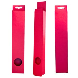 May include: Three red cardboard boxes with a hole in the center and a hanging loop at the top. The boxes are all the same size and shape.