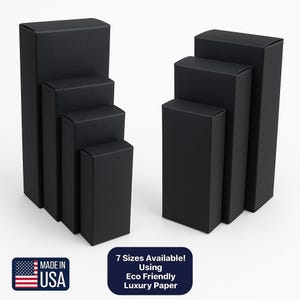 May include: Two groups of black rectangular boxes in different sizes. The boxes are made of a matte material. The image includes a "Made in USA" graphic and a text box stating "7 Sizes Available! Using Eco Friendly Luxury Paper."
