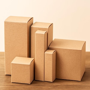 May include: A collection of various sized, brown cardboard boxes. The boxes are arranged in a group, with some standing upright and others lying on their sides. The boxes are made of a plain, unprinted cardboard material.