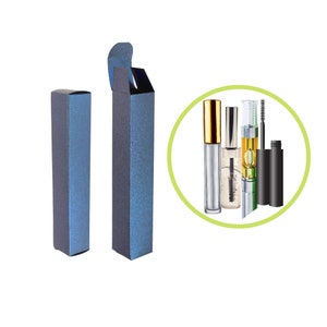 May include: A set of cosmetic products, including mascara and clear brow gel, with a metallic blue box. The mascara has a black tube and wand, while the brow gel has a clear tube with a gold cap. The products are displayed on a white background.