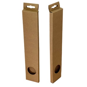 May include: Two brown cardboard boxes with a hanging hole at the top. Each box has a round cutout on the side.