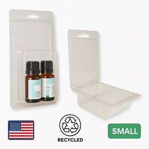 May include: Two small brown glass bottles with black caps are displayed in a clear plastic clamshell package. The package is labeled "SMALL" and includes a recycling symbol and an American flag.