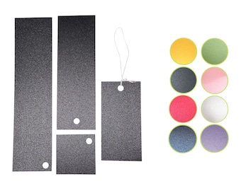 May include: Four black rectangular gift tags with holes for string. The tags have a textured surface and are arranged in a row. A small square tag is below the second tag. A row of nine colorful circles are on the right side of the image.