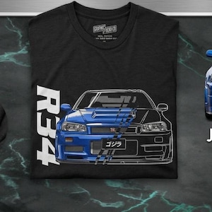 May include: Black t-shirt featuring a split design of a blue and black sports car, with the text "R34" in white. A blue sports car is on the right, with the text "JDM LEGEND". A silver GT emblem is on the left.
