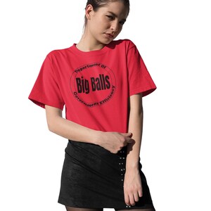 May include: A red t-shirt with a black circle graphic that says "Department of Big Balls Government Efficiency".