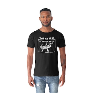 May include: A black t-shirt with a white graphic of a scuba diver and the word "Muff" printed on the front.