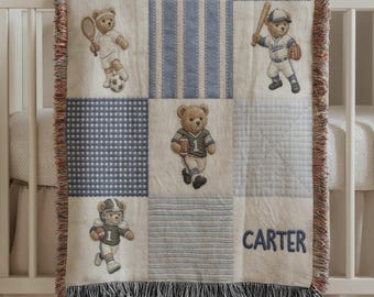 May include: A baby blanket with a patchwork design featuring teddy bears playing sports. The blanket has blue and white squares, stripes, and gingham patterns. The name "CARTER" is embroidered in blue. The blanket has a fringed edge.