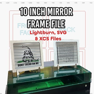 May include: Two 10 inch mirror frames made of wood with a light brown finish. The frames are standing on a table. One frame has a graphic of a snake with the words "Don't Tread On Me". The other frame has a document with the text "In Congress, July 4, 1776".