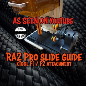 May include: A black and orange RA2 Pro Slide Guide for XTOOL F1/F2 attachment, as seen on YouTube. The image features the product with the text "AS SEEN ON YOUTUBE" and "THE CLACK SHACK" logo.