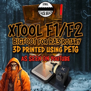 May include: Image of an XTOOL F1/F2 Bigfoot for RA3 Rotary 3D printed using PETG. The image includes the text "AS SEEN ON YOUTUBE" and a logo for "THE CLACK SHACK". The background features a Bigfoot illustration.
