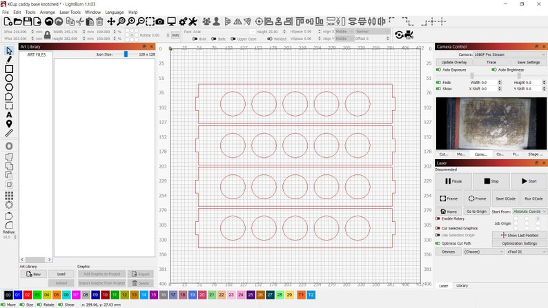 May include: A computer screen displaying a design for a laser cutter. The design is for a rectangular frame with 18 circular cutouts. The design is displayed on a grid with red lines.