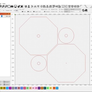 May include: A computer screen displaying a design program with a red octagon shape and three circles inside. The design is on a grid background.