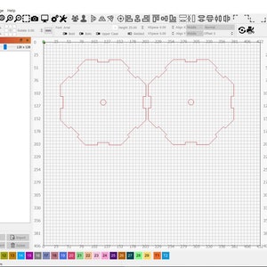 May include: A computer screen displaying a design program with a grid pattern. Two red octagonal shapes with a circle in the center are visible on the screen.