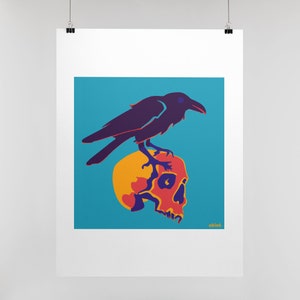 Op de afbeelding: Een rechthoekige kunstdruk met een donkerpaarse raaf die op een gele en oranje menselijke schedel zit tegen een felblauwe achtergrond. Het kunstwerk bevat de tekst "able6" in kleine gele letters in de rechterbenedenhoek.