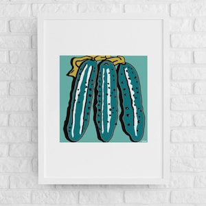 May include: Three teal green cucumbers with yellow tops and black speckles, arranged vertically on a teal green background.