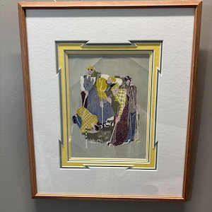 May include: Framed artwork featuring a group of figures in vintage attire, possibly playing croquet. The artwork has a light wood frame, a yellow and white mat, and a colorful illustration with figures in patterned clothing.
