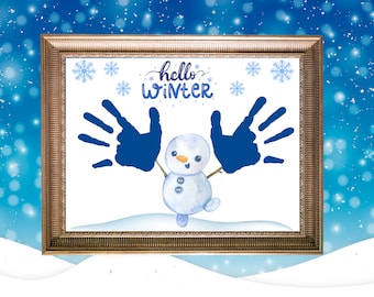 May include: A framed white background with the text "hello winter" in blue cursive writing. Two blue handprints are on either side of a cartoon snowman with a blue body, white buttons, and a carrot nose. There are small blue snowflakes scattered around the image.