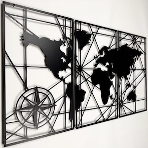 May include: Black metal wall art depicting a world map in three panels. The continents are solid black, set against a geometric grid. A compass rose is featured on the left panel, adding a navigational theme.