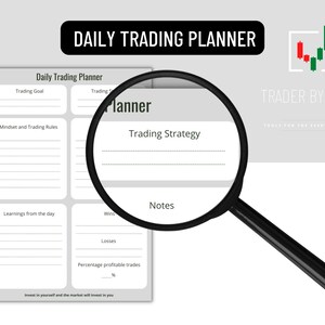 May include: A white Daily Trading Planner with sections for goals, rules, and notes. The planner is viewed through a magnifying glass. The text "DAILY TRADING PLANNER" is at the top. The logo "TRADER BY TRADE" is on the right.