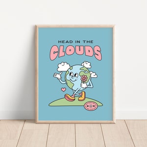 May include: A blue and green cartoon Earth with a pink flower and a smiling face, walking on a green path with the text "HEAD IN THE CLOUDS" in pink and blue letters. The Earth is wearing pink shoes and a pink heart is floating above it. The text "GOOD FOR THE SOUL GOOD FOR THE WORLD" is in a circle with a flower.