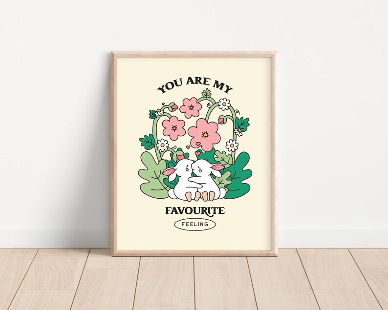 May include: A printable art print with a light yellow background featuring two white bunnies hugging in a garden with pink and white flowers. The text "You are my favourite feeling" is written in black letters.
