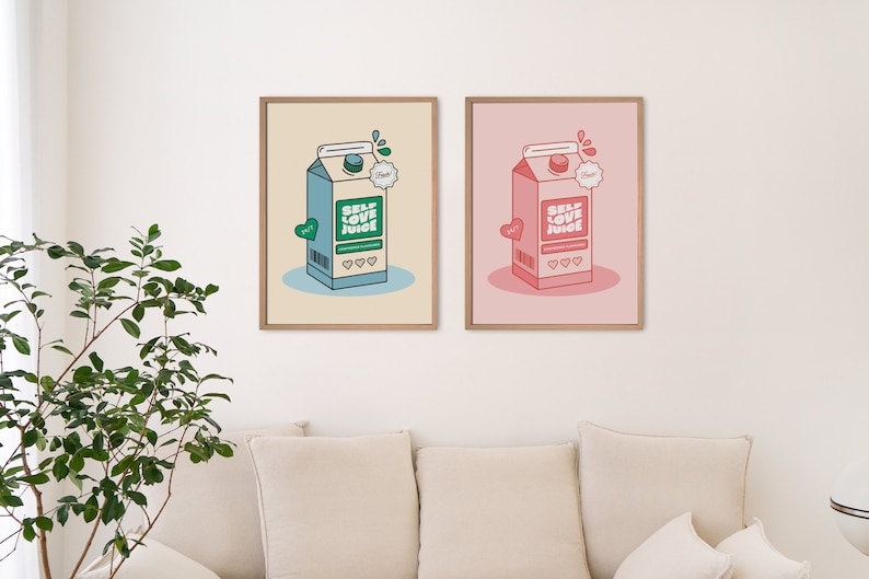 May include: Two framed prints of a cartoon illustration of a milk carton with the words "Self Love Juice" on it. The carton on the left is blue and green, and the carton on the right is pink and red.