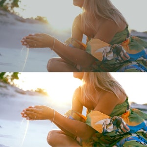Puede incluir: Una mujer con un vestido colorido sin hombros se sienta en una playa de arena, dejando que la arena se filtre entre sus dedos. El sol brilla intensamente en el fondo.