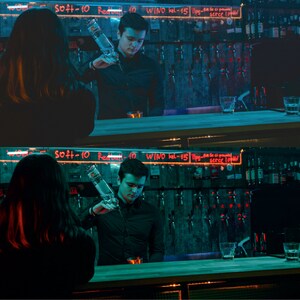 May include: A bartender pours a clear liquid from a bottle into a glass. The bartender is wearing a black shirt and the customer is wearing a black shirt. The bar is dimly lit and has a green and blue color scheme. The bar has a sign that says "WINO kel-15" in red letters.