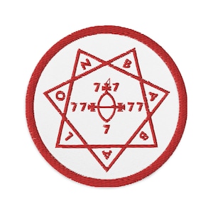 May include: A red embroidered patch featuring a white seven-pointed star in the centre. The star has the numbers 7, 777, 7, 777, 7, 4, 8, 2, and 4 around its points. The star is enclosed within a red circle.