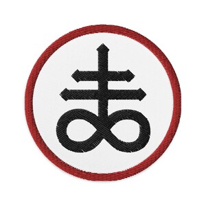 May include: A white embroidered patch with a red border, featuring a black inverted pentagram with an infinity symbol at the base.