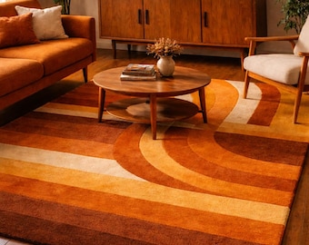 May include: A retro-style area rug with a striped design in shades of orange, brown, and cream. The rug features a curved pattern, adding a unique visual element to the room. The rug is placed on a wooden floor, complementing the warm tones.