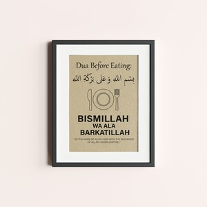 May include: Framed print with a black border. The print features text in Arabic and English, including "Dua Before Eating" and "BISMILLAH WA ALA BARKATILLAH." A simple illustration of a plate, knife, and fork is centered below the Arabic text.