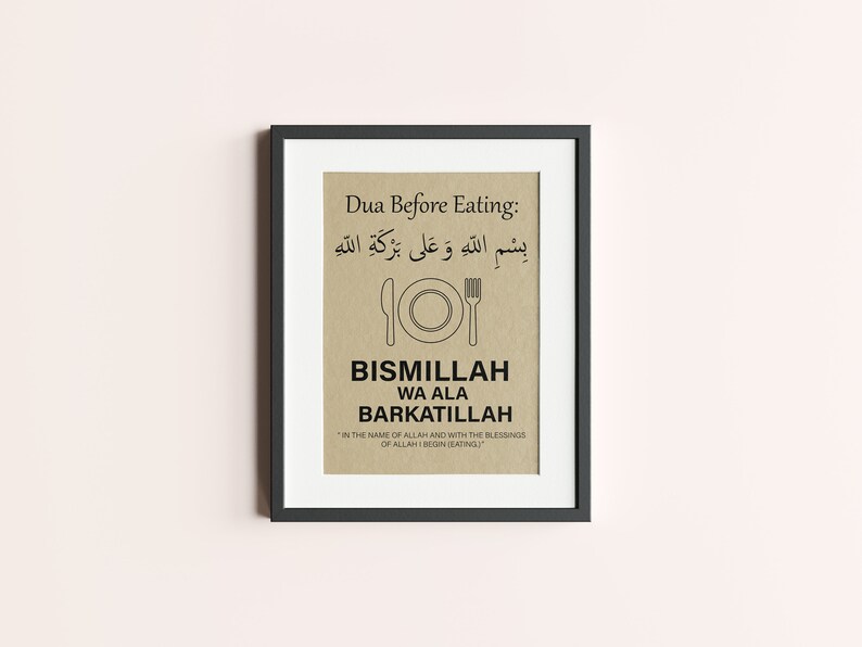 May include: Framed print with a black border. The print features text in Arabic and English, including "Dua Before Eating" and "BISMILLAH WA ALA BARKATILLAH." A simple illustration of a plate, knife, and fork is centered below the Arabic text.