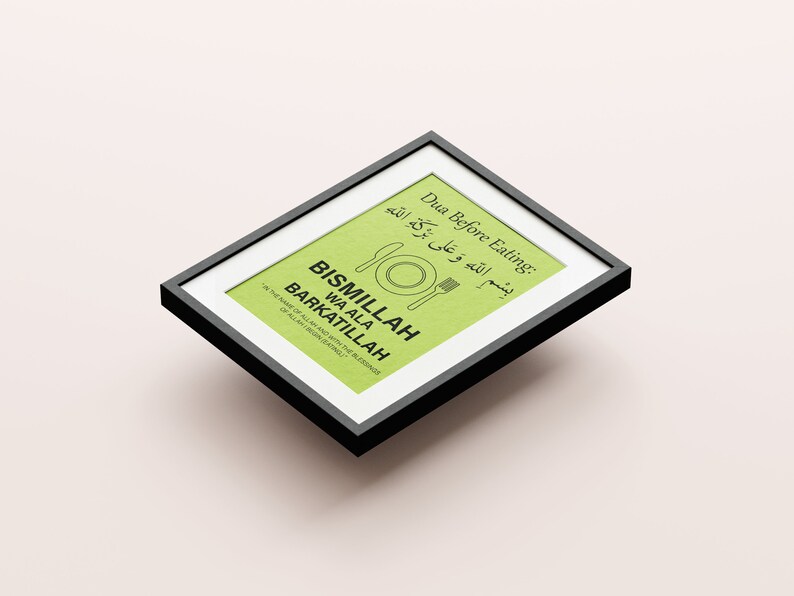 May include: Framed print with a black border. The print has a light green background with text in English and Arabic. The text includes "Dua Before Eating" and "BISMILLAH WA ALA BARKATILLAH". A fork, knife, and plate graphic are also present.